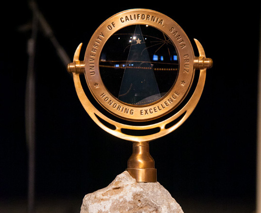 The Foundation Medal. Composed of limestone from the UCSC quarry and a lens crafted at UCSC’s Lick Optical Lab.